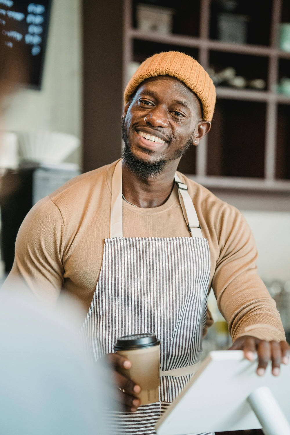 Friendly barista serving coffee